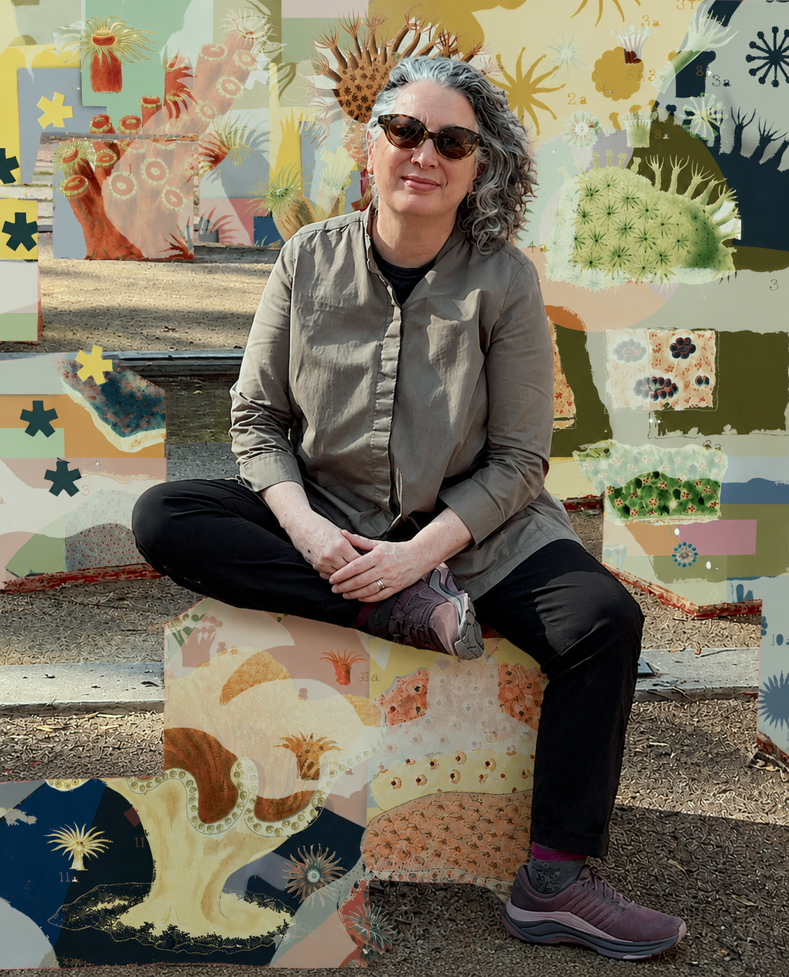 Gail Leija seated outdoors in front of her artwork